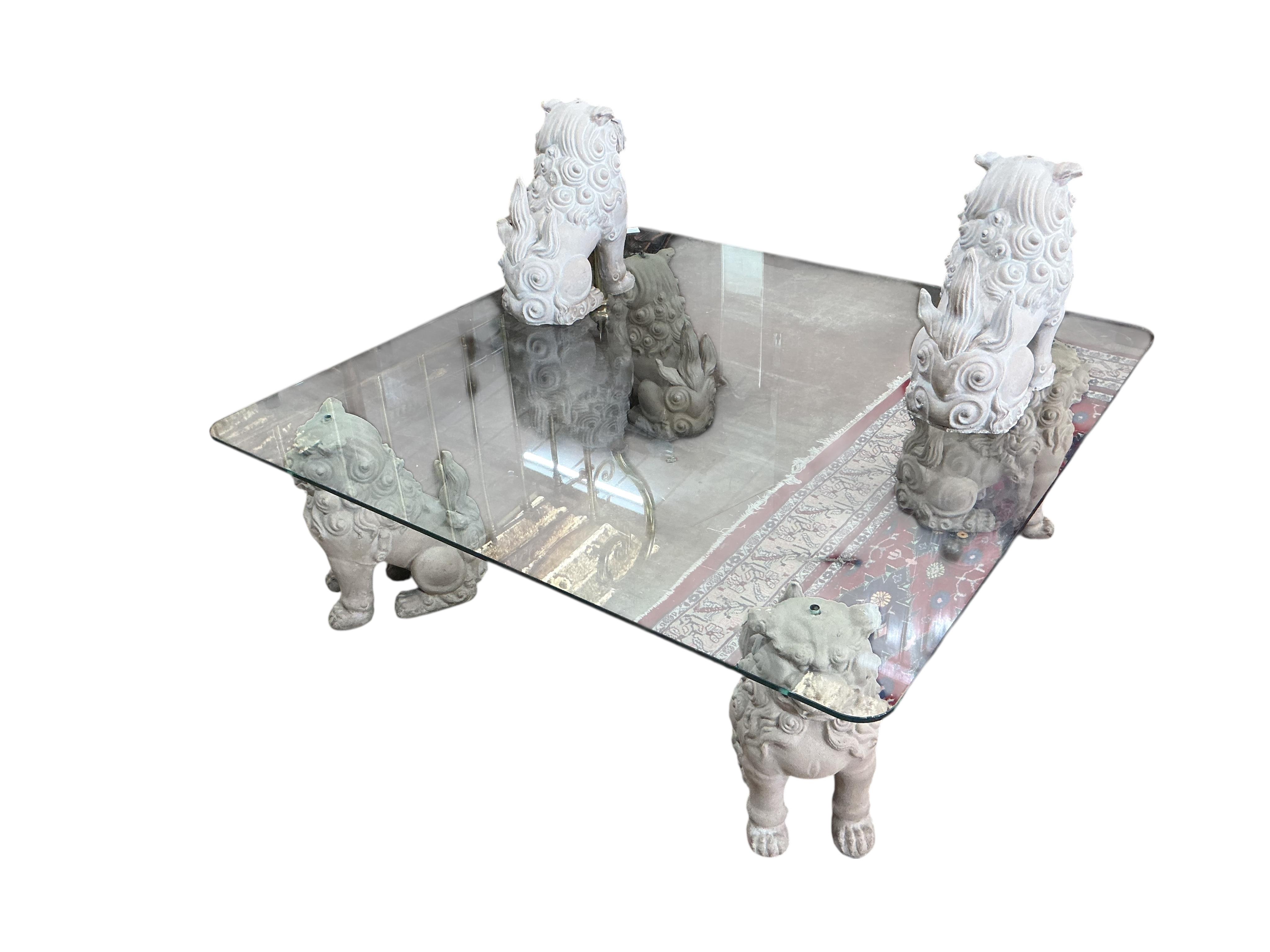 A square glass coffee table with composition shi-shi supports, 122cm, height 39cm